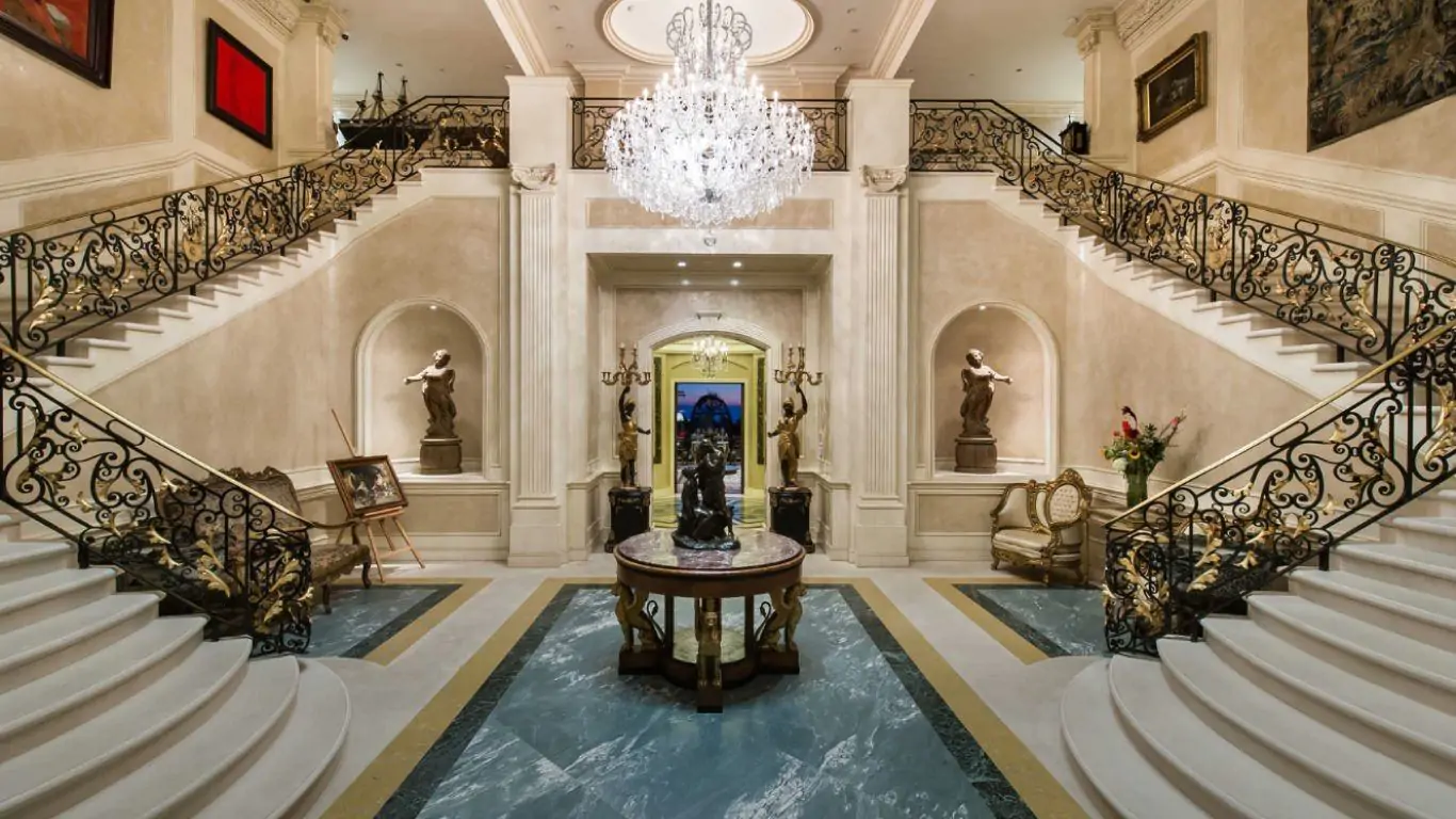 Grand foyer with regal double staircase and crystal chandelier